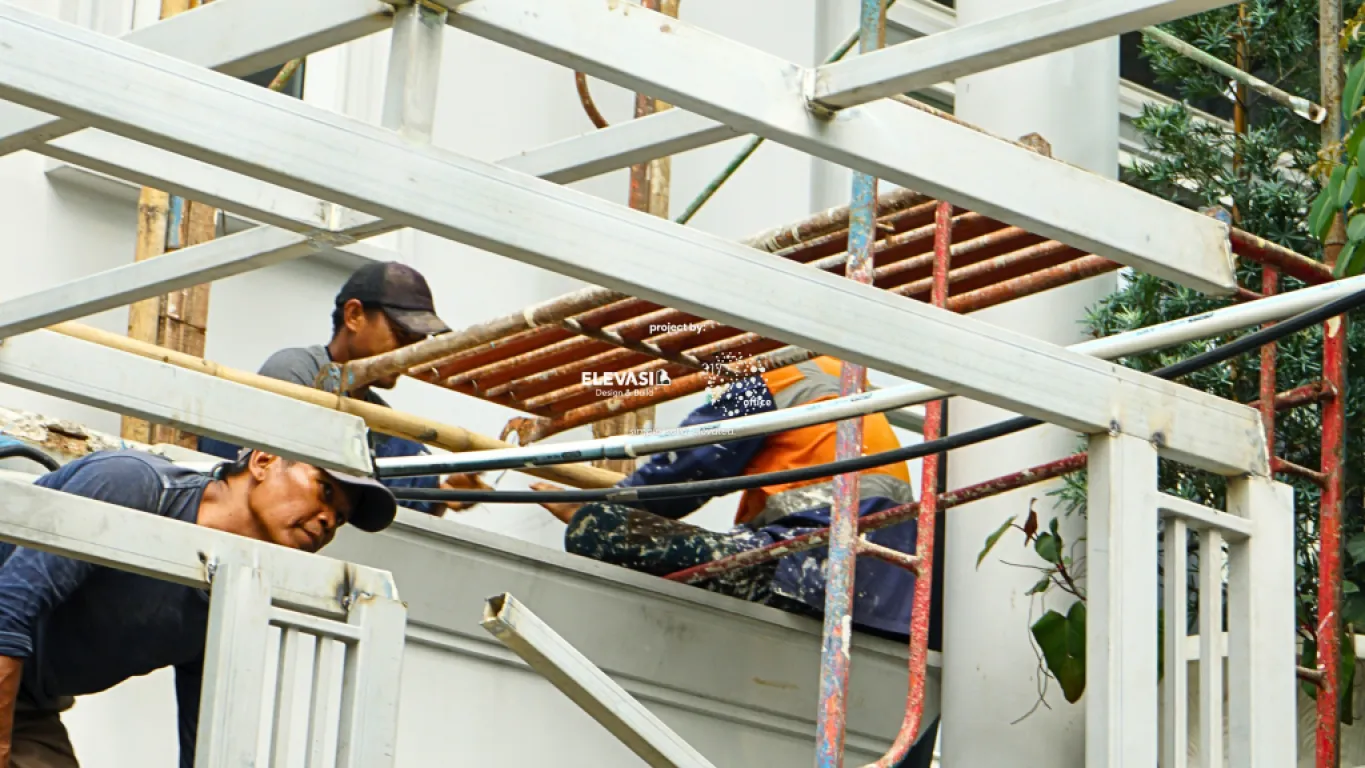 Construction workers installing a garage canopy