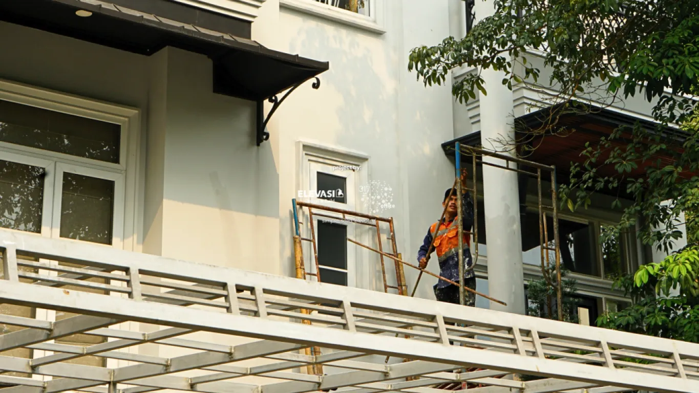 Construction workers installing a garage canopy